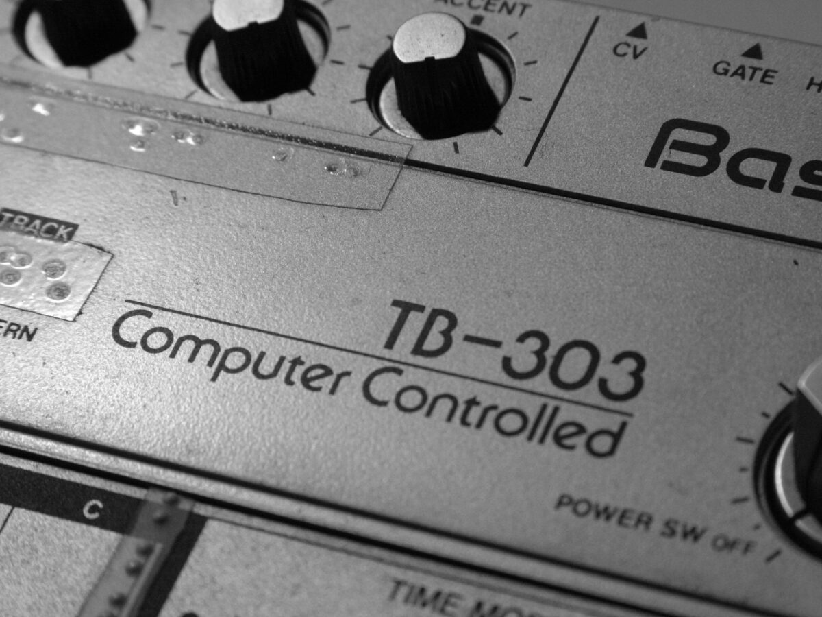Close-p of vintage TB-303 hardware showing "Computer-Controlled" logo and knobs. "Old Roland TB-303" by Alexandre Dulaunoy is licensed under CC BY-SA 2.0.