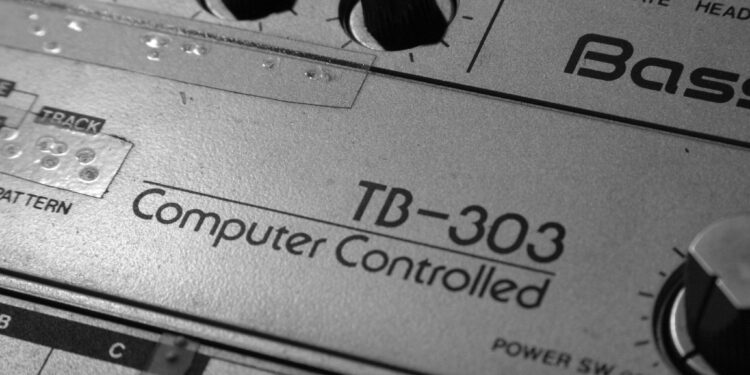 Close-p of vintage TB-303 hardware showing "Computer-Controlled" logo and knobs. "Old Roland TB-303" by Alexandre Dulaunoy is licensed under CC BY-SA 2.0.